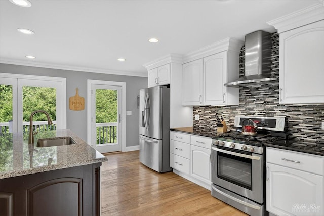 1714 Il Route 173, Spring Grove, IL 60081 - kitchen featuring stainless steel appliances, wall chimney exhaust hood, a sink, backsplash, and dark stone counters