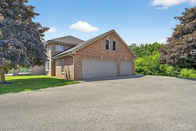 1714 Il Route 173, Spring Grove, IL 60081 - traditional-style home featuring brick siding, a front lawn, driveway, and a garage