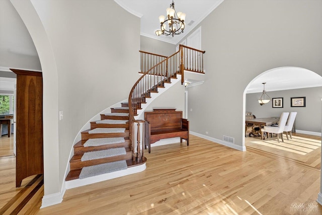 1714 Il Route 173, Spring Grove, IL 60081 - staircase featuring arched walkways, wood finished floors, baseboards, a chandelier, and crown molding