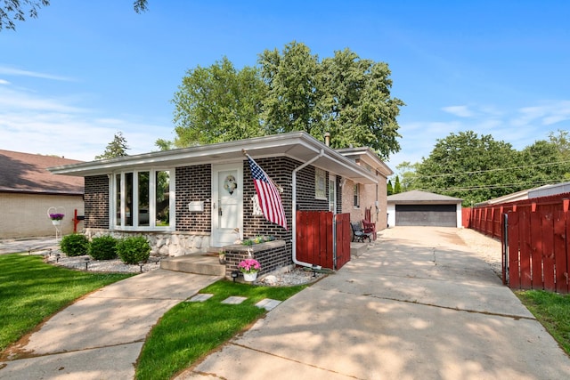 14447 Kolin Ave, Midlothian, IL 60445 - view of front of house featuring brick siding, a detached garage, and an outbuilding