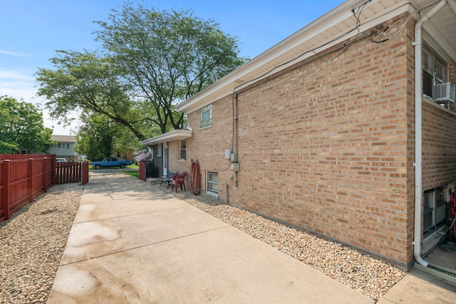 14447 Kolin Ave, Midlothian, IL 60445 - view of property exterior featuring brick siding, a patio, and cooling unit