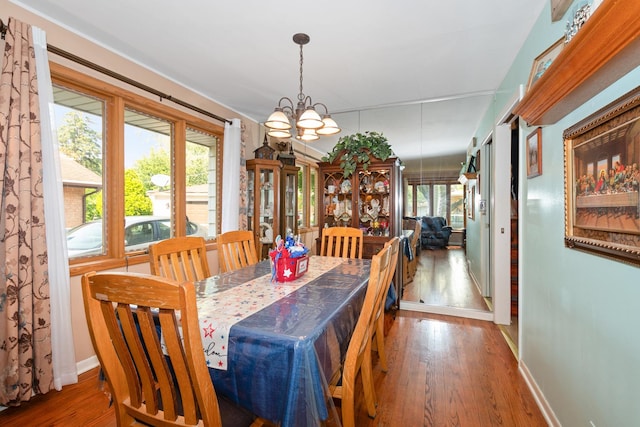 14447 Kolin Ave, Midlothian, IL 60445 - dining room featuring a chandelier, wood finished floors, and healthy amount of natural light