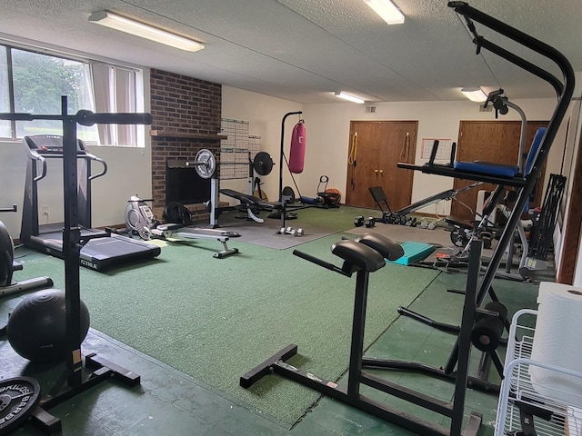 1503 Woodbridge Rd Unit 1F, Joliet, IL 60436 - gym with a textured ceiling and a fireplace