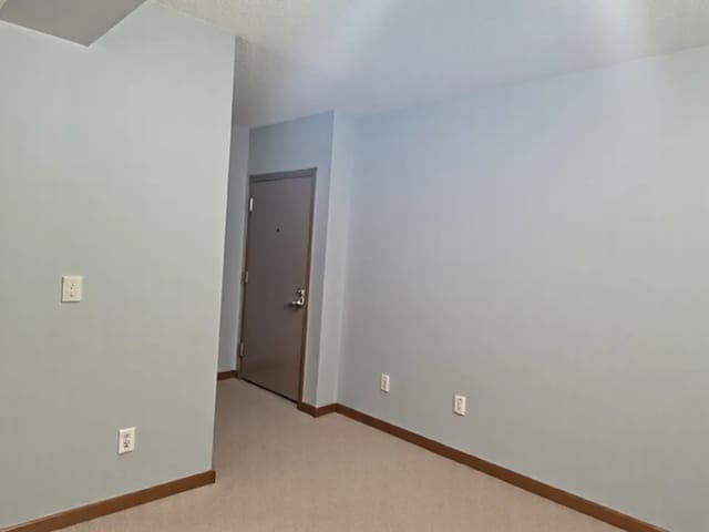 1503 Woodbridge Rd Unit 1F, Joliet, IL 60436 - unfurnished room featuring baseboards and light carpet
