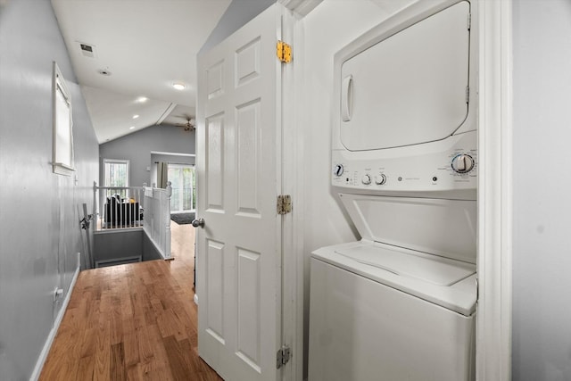 5905 S Indiana Ave, Chicago, IL 60637 - laundry area featuring stacked washing machine and dryer, wood finished floors, a ceiling fan, and baseboards