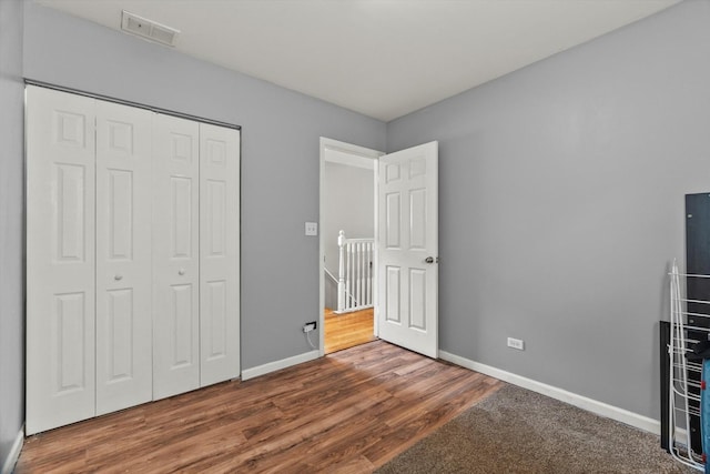 5905 S Indiana Ave, Chicago, IL 60637 - unfurnished bedroom with baseboards, wood finished floors, and a closet