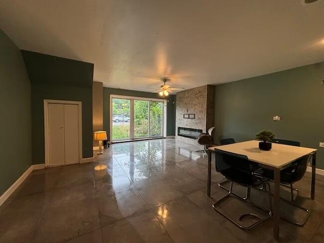 5905 S Indiana Ave, Chicago, IL 60637 - dining room featuring a stone fireplace, baseboards, and ceiling fan