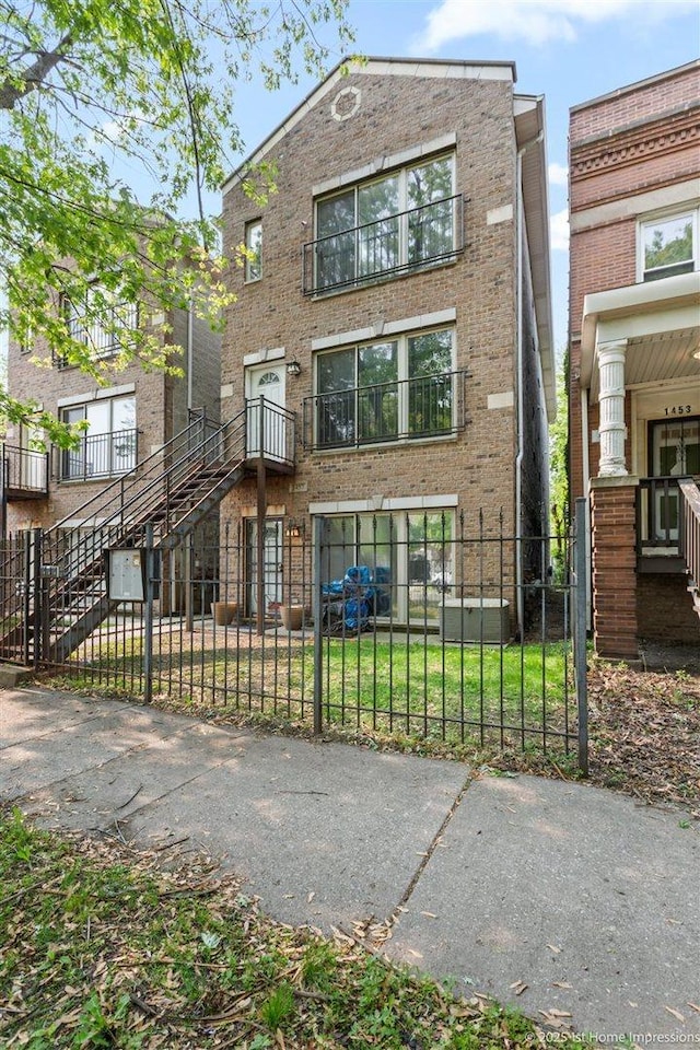 1457 E 71st Pl Unit 3, Chicago, IL 60619 - view of front facade with a fenced front yard, brick siding, stairs, and a gate