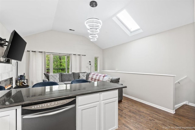 1457 E 71st Pl Unit 3, Chicago, IL 60619 - kitchen featuring stainless steel dishwasher, a skylight, lofted ceiling, open floor plan, and white cabinetry