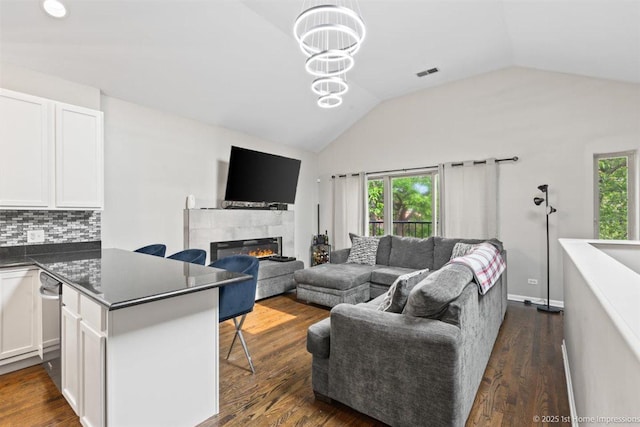 1457 E 71st Pl Unit 3, Chicago, IL 60619 - living room with vaulted ceiling, dark wood-style floors, and a tiled fireplace