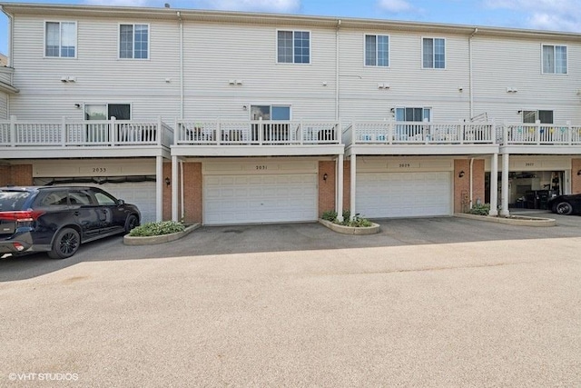 2031 Concord Dr Unit 2031, Mchenry, IL 60050 - back of property featuring an attached garage, brick siding, and driveway