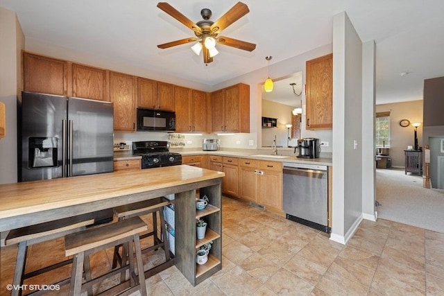 2031 Concord Dr Unit 2031, Mchenry, IL 60050 - kitchen with black appliances, light countertops, a ceiling fan, brown cabinetry, and open shelves