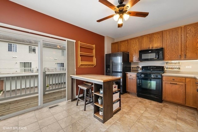 2031 Concord Dr Unit 2031, Mchenry, IL 60050 - kitchen with black appliances, ceiling fan, open shelves, brown cabinetry, and light countertops