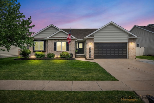 1125 Oxford Cir, Sycamore, IL 60178 - single story home with concrete driveway, an attached garage, a front lawn, and brick siding