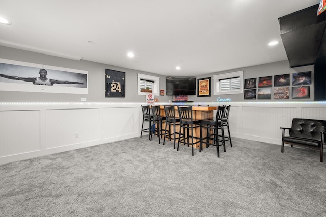 1125 Oxford Cir, Sycamore, IL 60178 - carpeted dining room featuring a dry bar, a decorative wall, recessed lighting, healthy amount of natural light, and a wainscoted wall