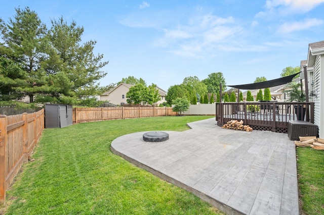 1125 Oxford Cir, Sycamore, IL 60178 - fenced backyard featuring an outdoor fire pit, a patio, a storage shed, and a deck