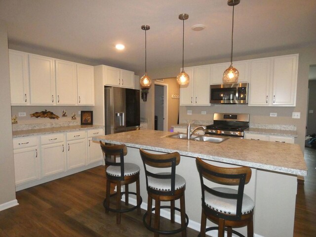 502 Silver Falls St, Joliet, IL 60431 - kitchen with appliances with stainless steel finishes, a sink, white cabinetry, dark wood-style flooring, and light countertops