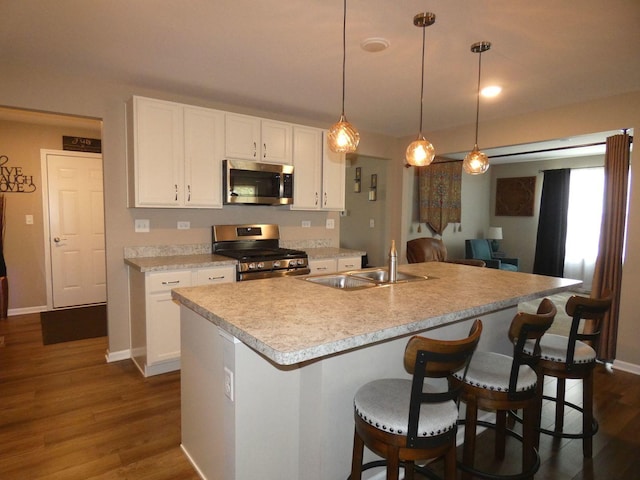 502 Silver Falls St, Joliet, IL 60431 - kitchen featuring stainless steel appliances, a sink, white cabinetry, and dark wood finished floors