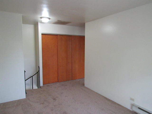 13 Saint Thomas Colony Unit 2, Fox Lake, IL 60020 - unfurnished bedroom with a baseboard radiator, carpet floors, and a closet