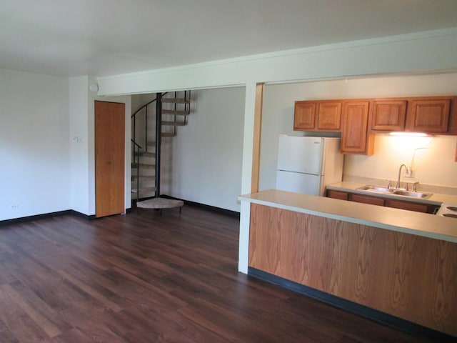 13 Saint Thomas Colony Unit 2, Fox Lake, IL 60020 - kitchen with freestanding refrigerator, a sink, dark wood-style flooring, light countertops, and brown cabinetry