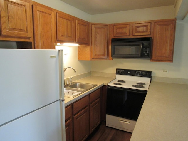 13 Saint Thomas Colony Unit 2, Fox Lake, IL 60020 - kitchen featuring white appliances, a sink, light countertops, brown cabinets, and dark wood-style flooring