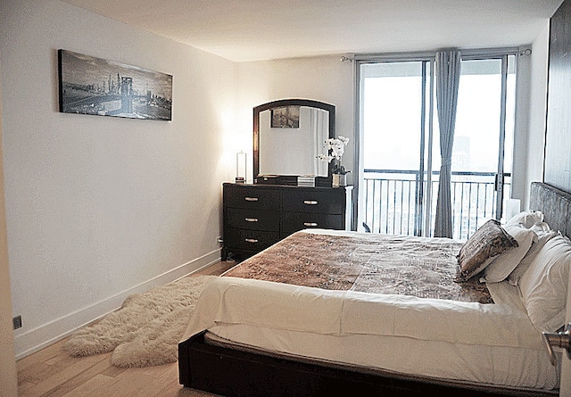 6007 N Sheridan Rd Unit 38G, Chicago, IL 60660 - bedroom featuring wood finished floors and access to exterior