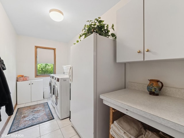 1520 Grant St, Schaumburg, IL 60193 - laundry area featuring washer and clothes dryer, cabinet space, and light tile patterned floors