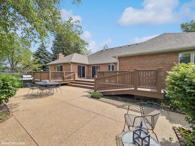 1520 Grant St, Schaumburg, IL 60193 - rear view of property with brick siding, a patio area, a deck, roof with shingles, and a chimney