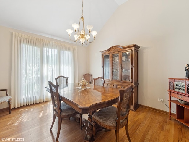 1520 Grant St, Schaumburg, IL 60193 - dining room featuring a chandelier, light wood-type flooring, and high vaulted ceiling