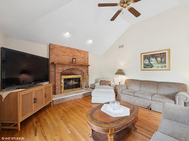 1520 Grant St, Schaumburg, IL 60193 - living area featuring vaulted ceiling, ceiling fan, light wood-style flooring, and a brick fireplace
