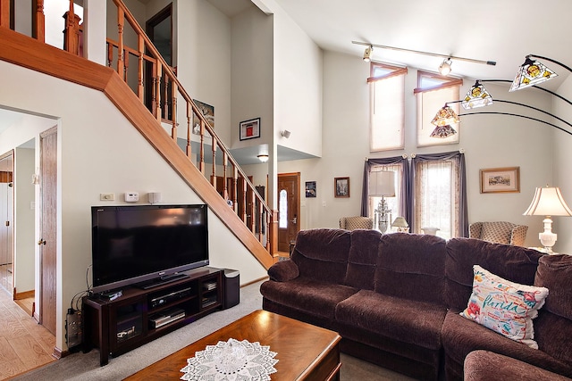 17007 Westwood Ct, Orland Hills, IL 60487 - living room featuring a high ceiling, stairs, track lighting, wood finished floors, and baseboards