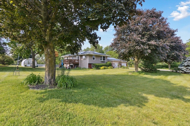 14710 Keslinger Rd, Dekalb, IL 60115 - view of side of home with a yard, a wooden deck, and a garage