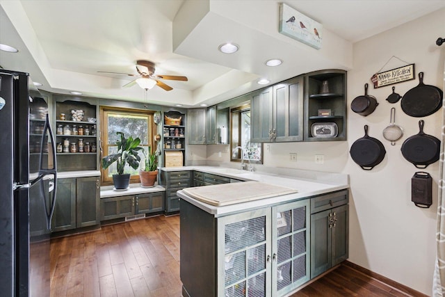 14710 Keslinger Rd, Dekalb, IL 60115 - kitchen with freestanding refrigerator, open shelves, a peninsula, a ceiling fan, and dark wood-type flooring