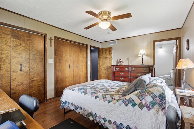 14710 Keslinger Rd, Dekalb, IL 60115 - bedroom featuring wood finished floors, crown molding, two closets, a ceiling fan, and a desk