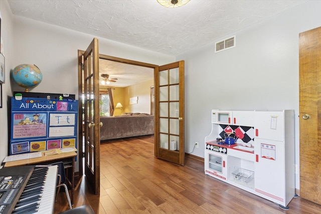 14710 Keslinger Rd, Dekalb, IL 60115 - game room with wood finished floors, a textured ceiling, french doors, and ceiling fan