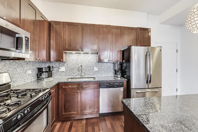 1464 S Michigan Ave Unit 1609, Chicago, IL 60605 - kitchen with appliances with stainless steel finishes, dark stone counters, decorative backsplash, and dark wood finished floors
