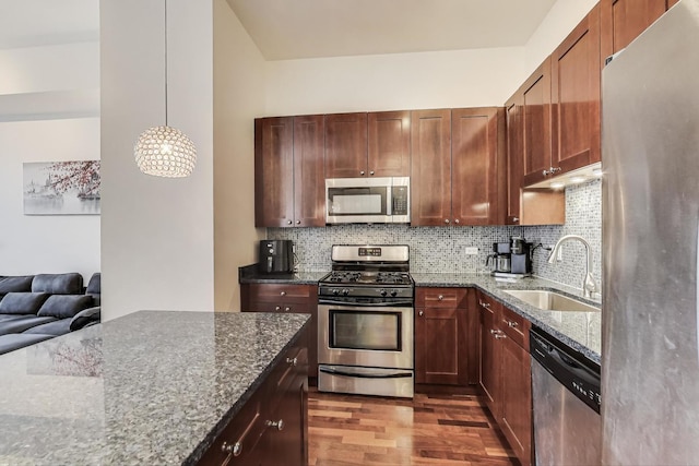 1464 S Michigan Ave Unit 1609, Chicago, IL 60605 - kitchen featuring stainless steel appliances, dark wood-style floors, dark stone countertops, and tasteful backsplash
