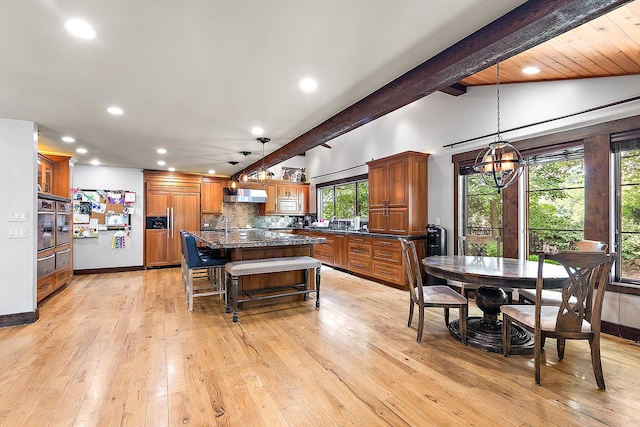 2500 Wahoo Ct, Morris, IL 60450 - kitchen with exhaust hood, brown cabinets, recessed lighting, paneled fridge, and backsplash