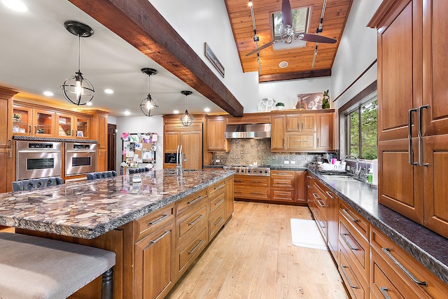 2500 Wahoo Ct, Morris, IL 60450 - kitchen with appliances with stainless steel finishes, recessed lighting, brown cabinets, light wood-style flooring, and a large island with sink