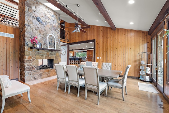 2500 Wahoo Ct, Morris, IL 60450 - dining room featuring wood walls, wood finished floors, a fireplace, and ceiling fan