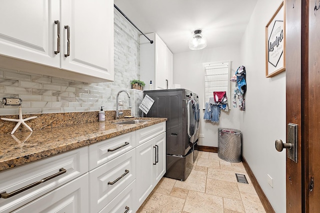 2500 Wahoo Ct, Morris, IL 60450 - laundry room featuring independent washer and dryer, cabinet space, and stone tile floors