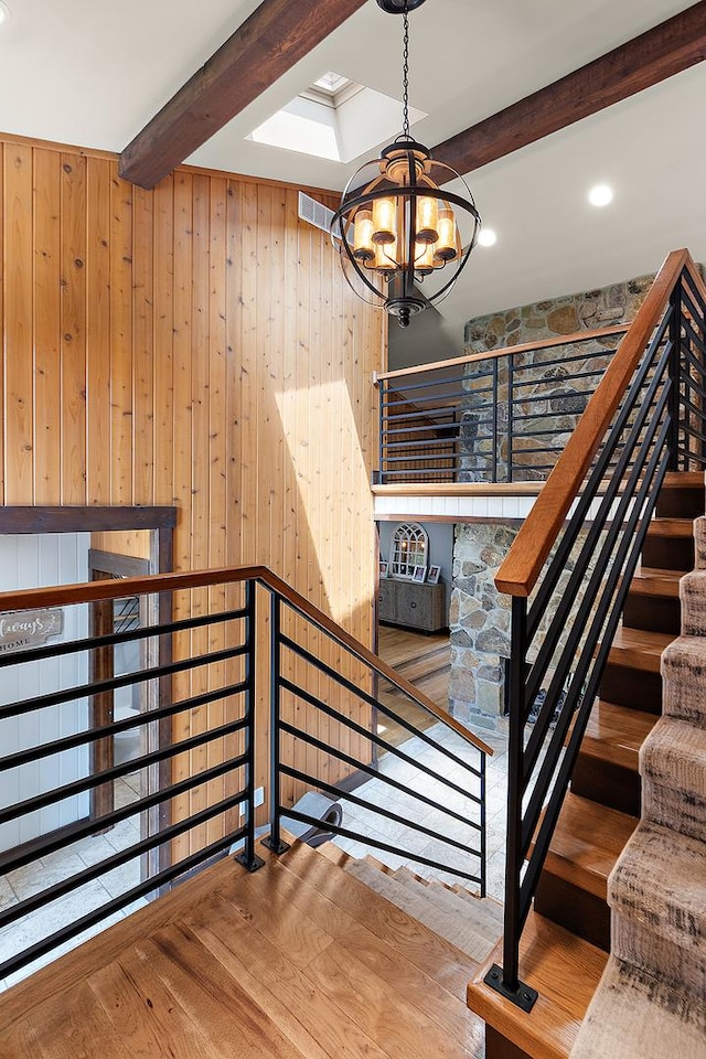 2500 Wahoo Ct, Morris, IL 60450 - staircase with a chandelier, beam ceiling, wood finished floors, wooden walls, and recessed lighting