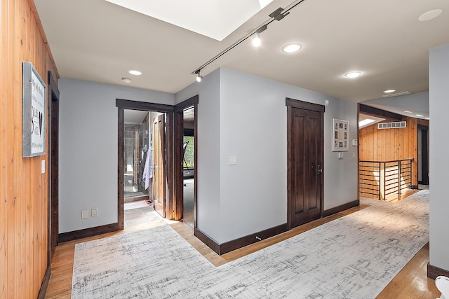 2500 Wahoo Ct, Morris, IL 60450 - corridor with light wood-style flooring, wood walls, recessed lighting, and an upstairs landing