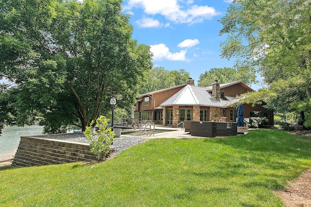 2500 Wahoo Ct, Morris, IL 60450 - rear view of property featuring a chimney, a patio area, a yard, and a metal roof