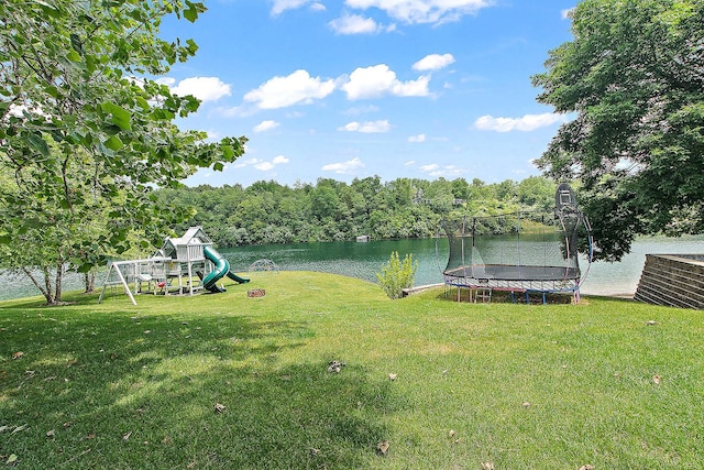 2500 Wahoo Ct, Morris, IL 60450 - view of green lawn with a trampoline, a playground, and a water view