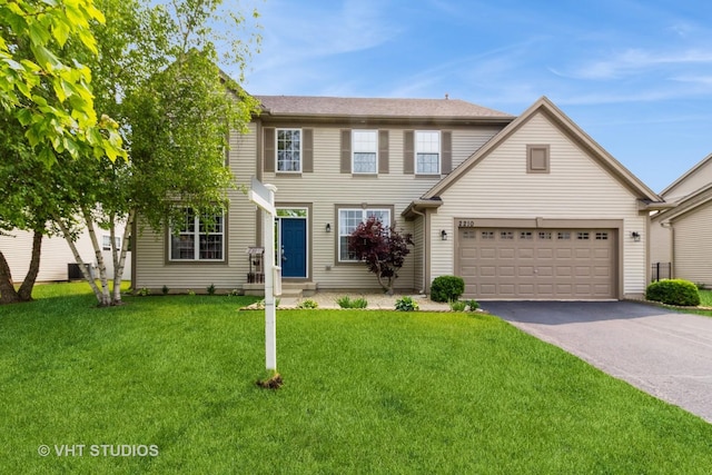 2210 Surrey St, Sycamore, IL 60178 - colonial home with asphalt driveway, a front lawn, and a garage