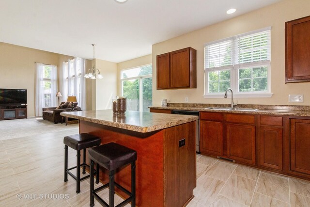 2210 Surrey St, Sycamore, IL 60178 - kitchen featuring healthy amount of natural light, dishwasher, a kitchen island, and a kitchen bar