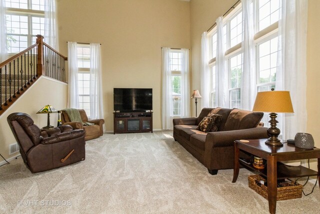 2210 Surrey St, Sycamore, IL 60178 - carpeted living room featuring a towering ceiling and stairs