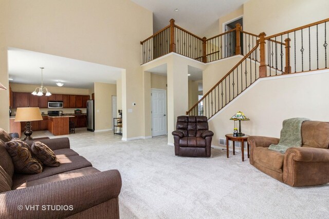 2210 Surrey St, Sycamore, IL 60178 - living room with a chandelier, stairs, light colored carpet, and a high ceiling