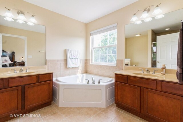 2210 Surrey St, Sycamore, IL 60178 - full bath featuring a garden tub, two vanities, tile patterned flooring, and a shower